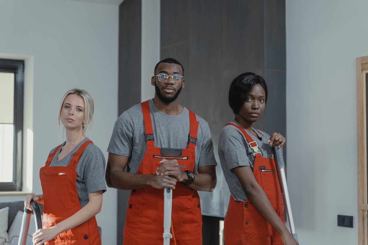 service-02 A diverse team of cleaning professionals in uniform posing in an indoor setting.